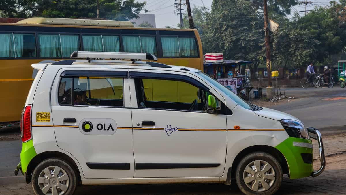 Ola car on street in Agra, India. Agra is included on the Golden Triangle tourist circuit, along with Delhi and Jaipur