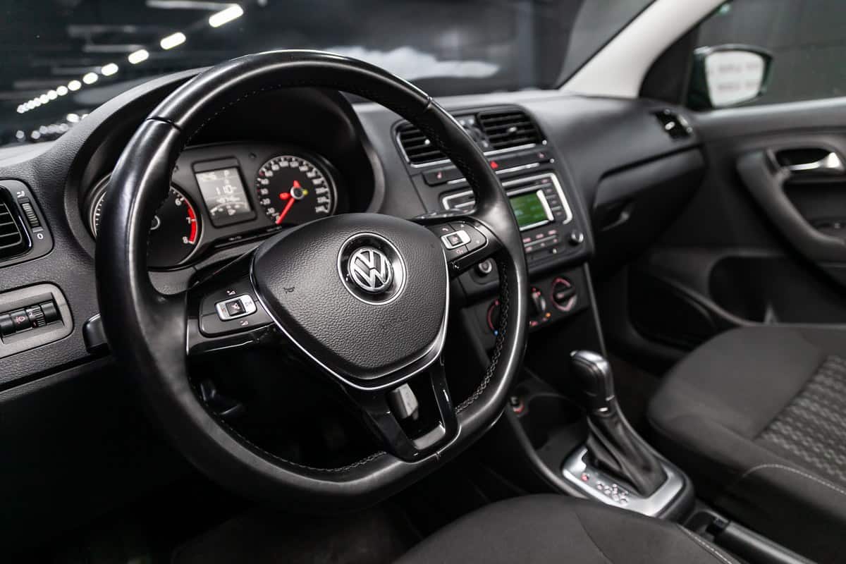 Volkswagen Polo, Black luxury car Interior - steering wheel, shift lever, multimedia systeme, driver seats and dashboard