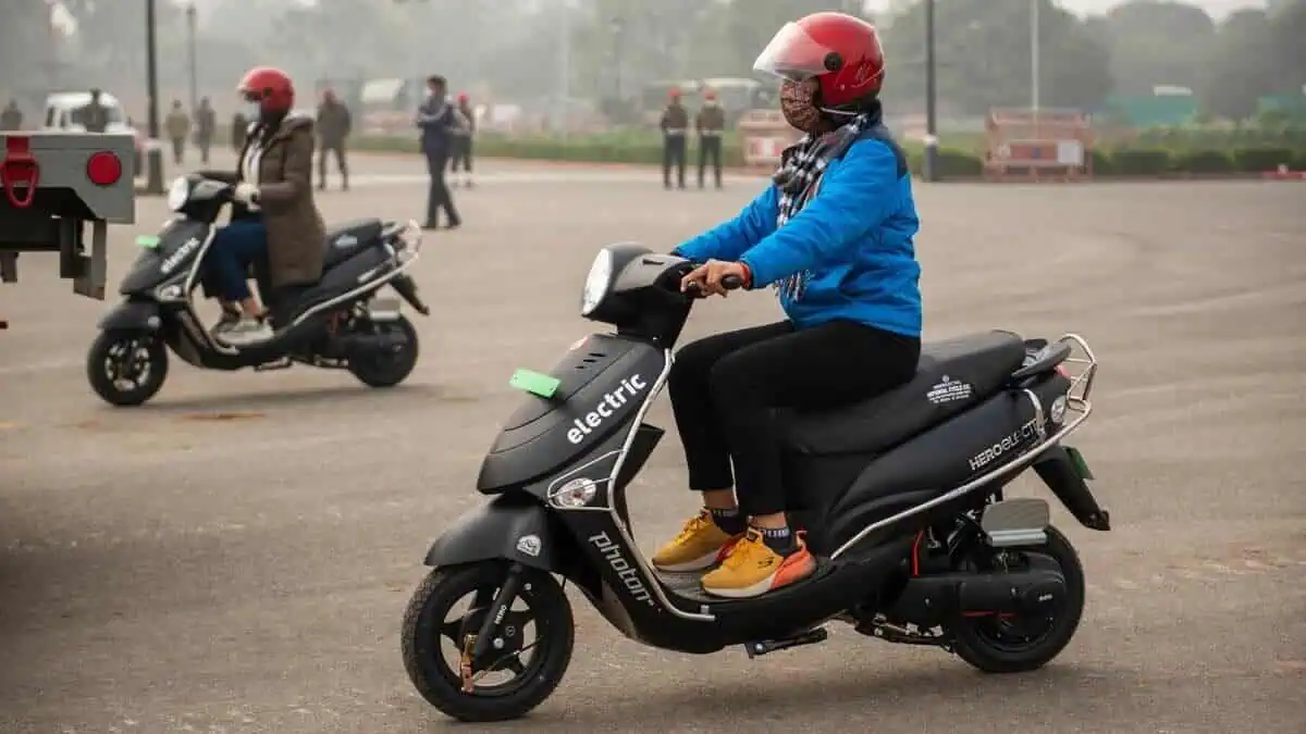 Woman ridding Electric Hero electric scooter during the Republic day rehearsal Parade at Raj path, New Delhi. Hero Electric Photon Hx