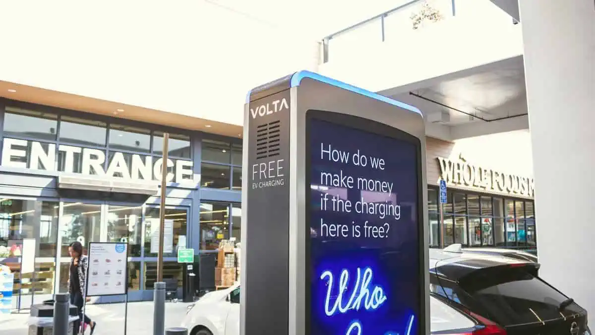 An electric vehicle parked next to a Volta charging pump