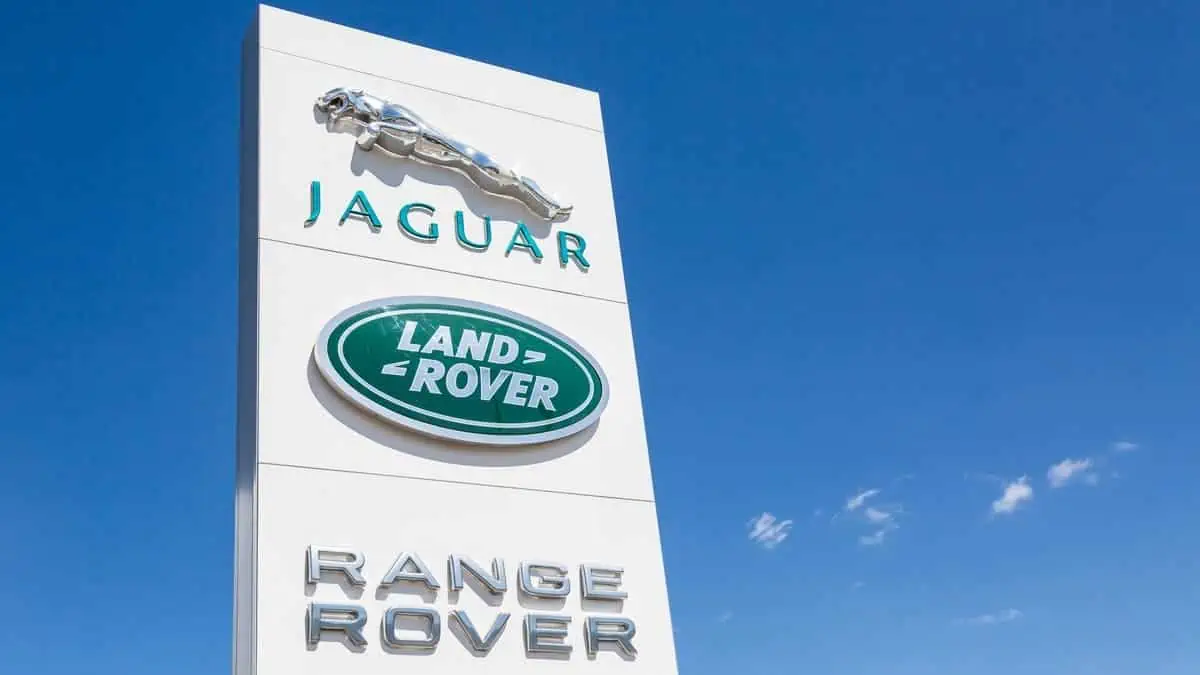 Jaguar and Land Rover logo sign against blue sky