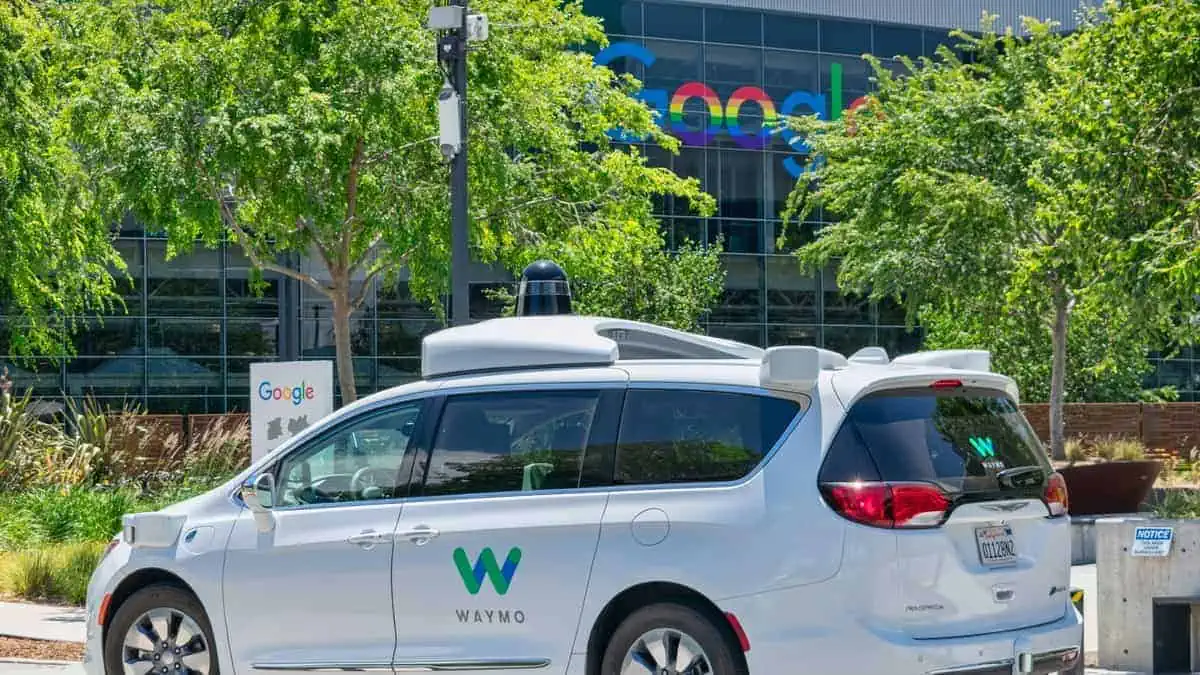 Waymo self driving car performing tests in a parking lot near Google's headquarters