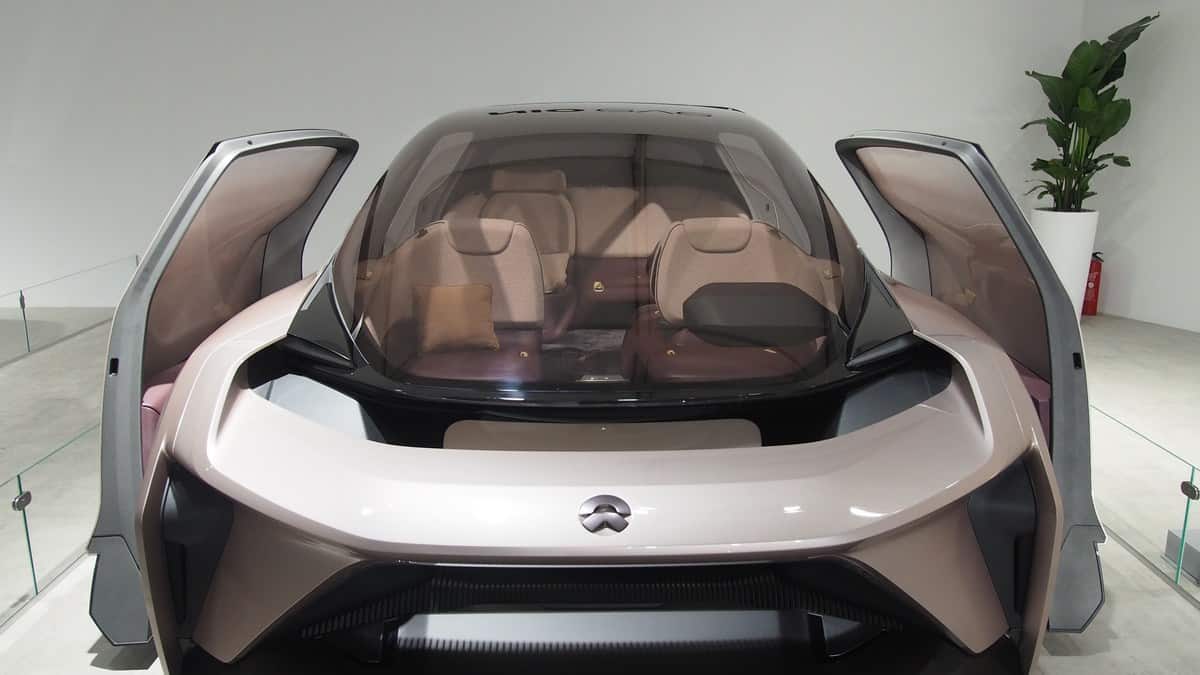 front view of a pale pink Nio Eve concept car with open sliding doors