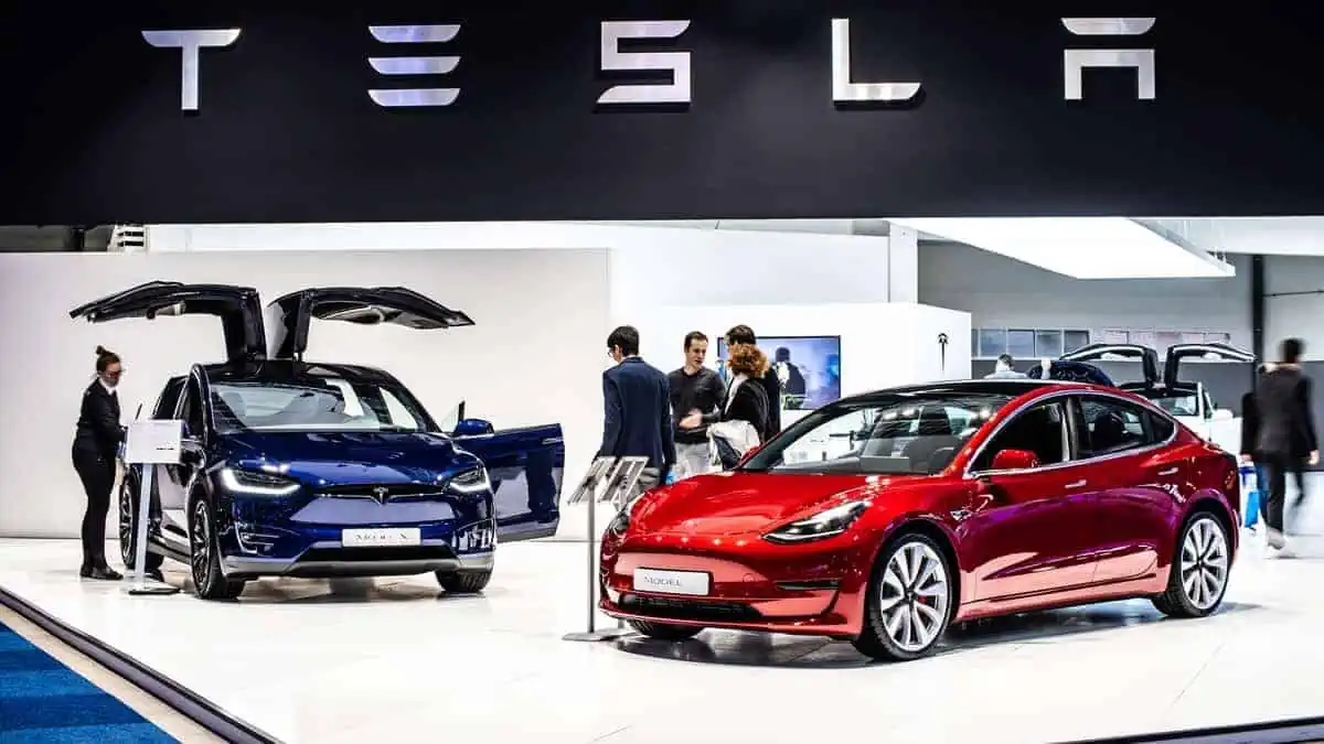 metallic red Tesla Model 3 and blue Tesla model X at Brussels Motor Show,