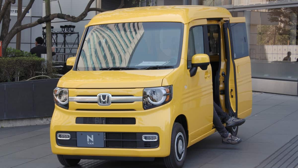 Honda N-Van parked outside a Honda showroom in Tokyo.