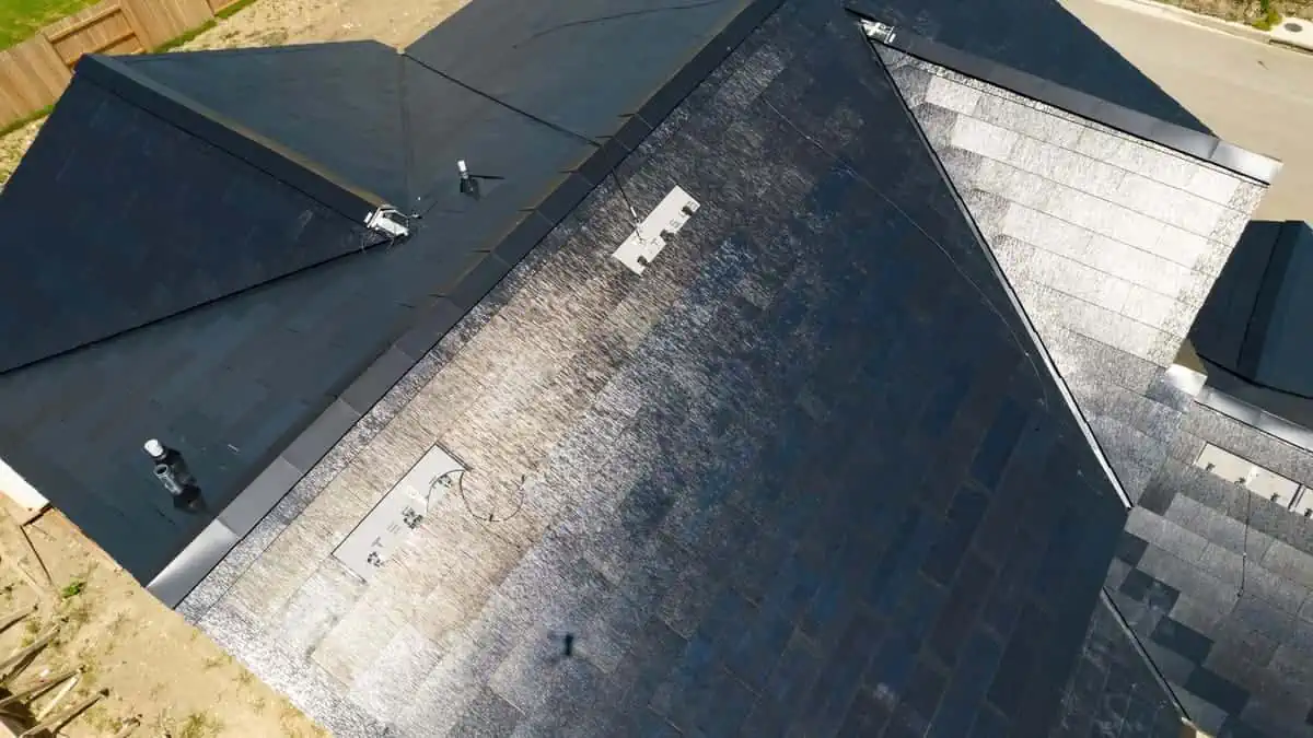Austin , Texas , USA - July 19th 2021 Tesla Solar Roof Tile Shingles producing solar energy combined with a Home Powerwall for a sustainable home capable of Off-Grid solar production.