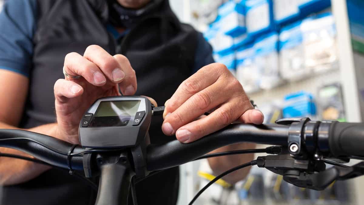 Bike mechanic maintains an e-bike