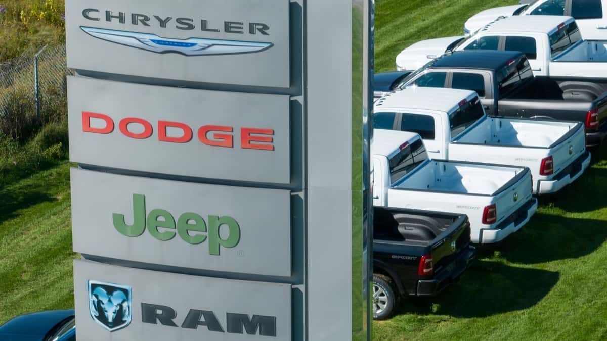 Innisfil, ON, Canada - September 30, 2022 A sign with the Chrysler, Dodge, Jeep and RAM logos on into, out from a large car dealership selling the popular Stellantis brands.