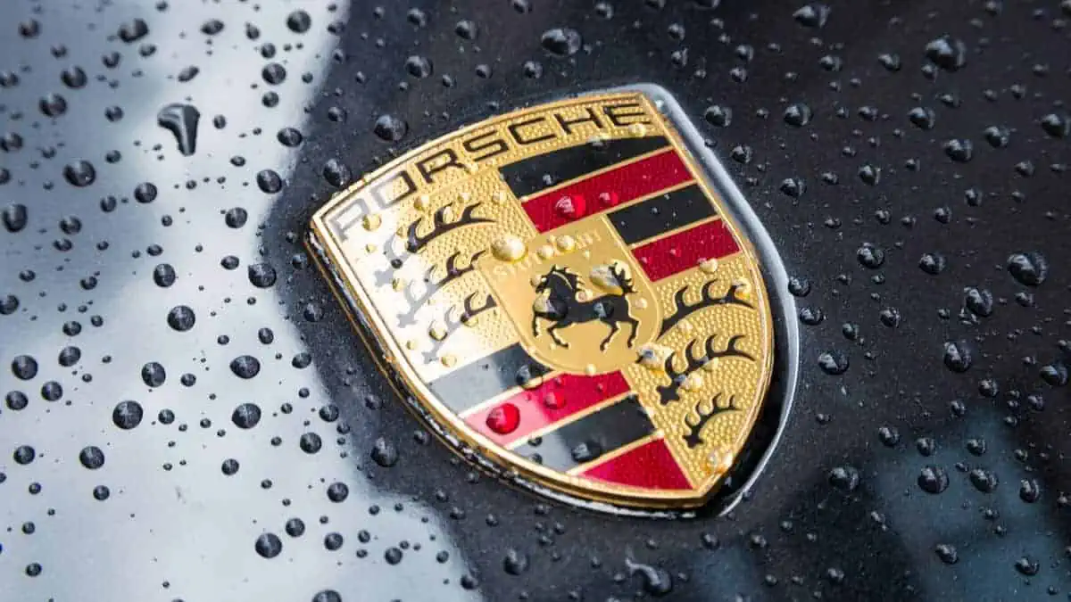 LONDON, UNITED KINGDOM MAY, 2017 Porsche Logo Close Up on a black car with rain drops. Ferdinand Porsche founded the company in 1931 with main offices in the centre of Stuttgart.