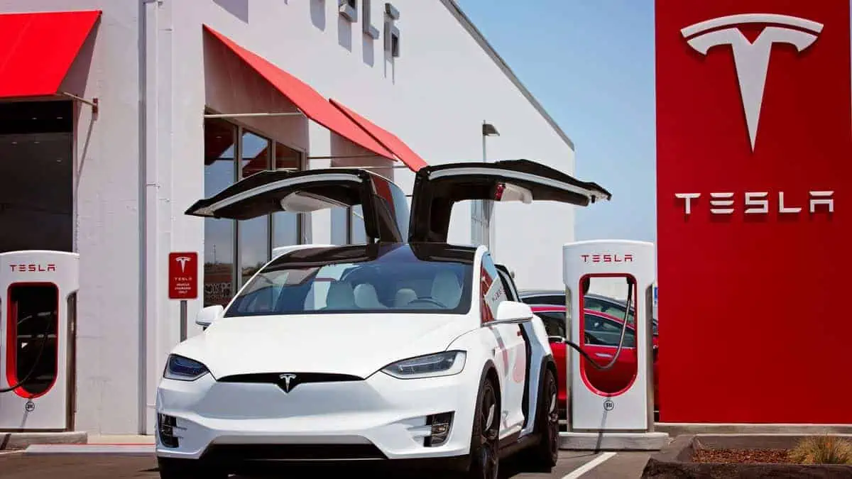 Seaside, CA - May 29, 2016 white tesla model x with falcon wing doors open charging at supercharger station