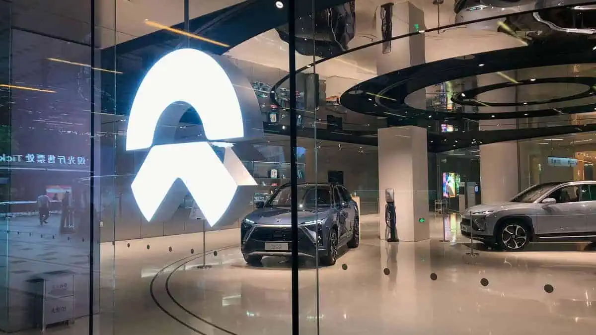Shanghai, China - Sep 3, 2020 NIO logo and the NIO store in downtown. Retail display of store at Shanghai Center mall in night. NIO is a Chinese electric car brand. NIO cars inside the store