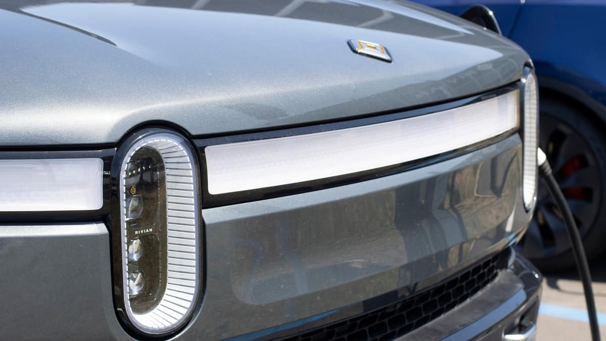 South San Francisco, CA, USA - May 1, 2022 Closeup of a new Rivian R1T truck charging at a Rivian service center in South San Francisco, California. Rivian Automotive, Inc. is an American EV startup.