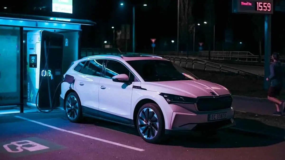 Tønsberg, Norway - may 15, 2021 white Skoda enyaq IV is a suv electric car. New car on a charging station during the night