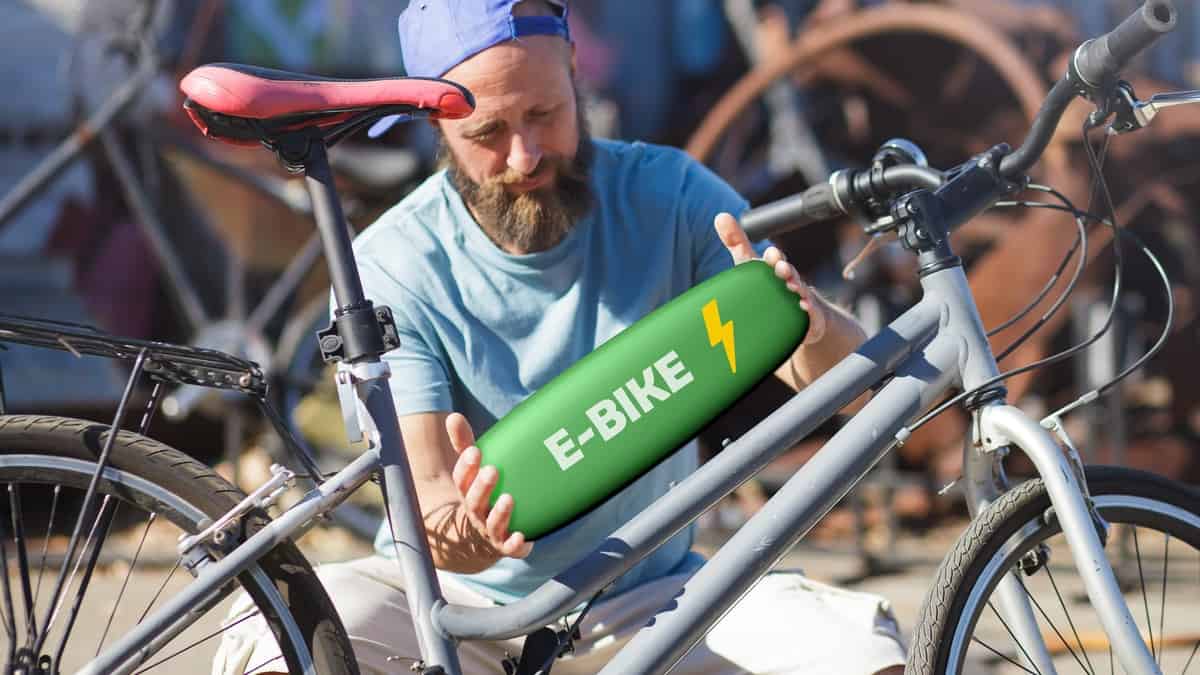 bicycle mechanic repairing and converting a bike to electric system